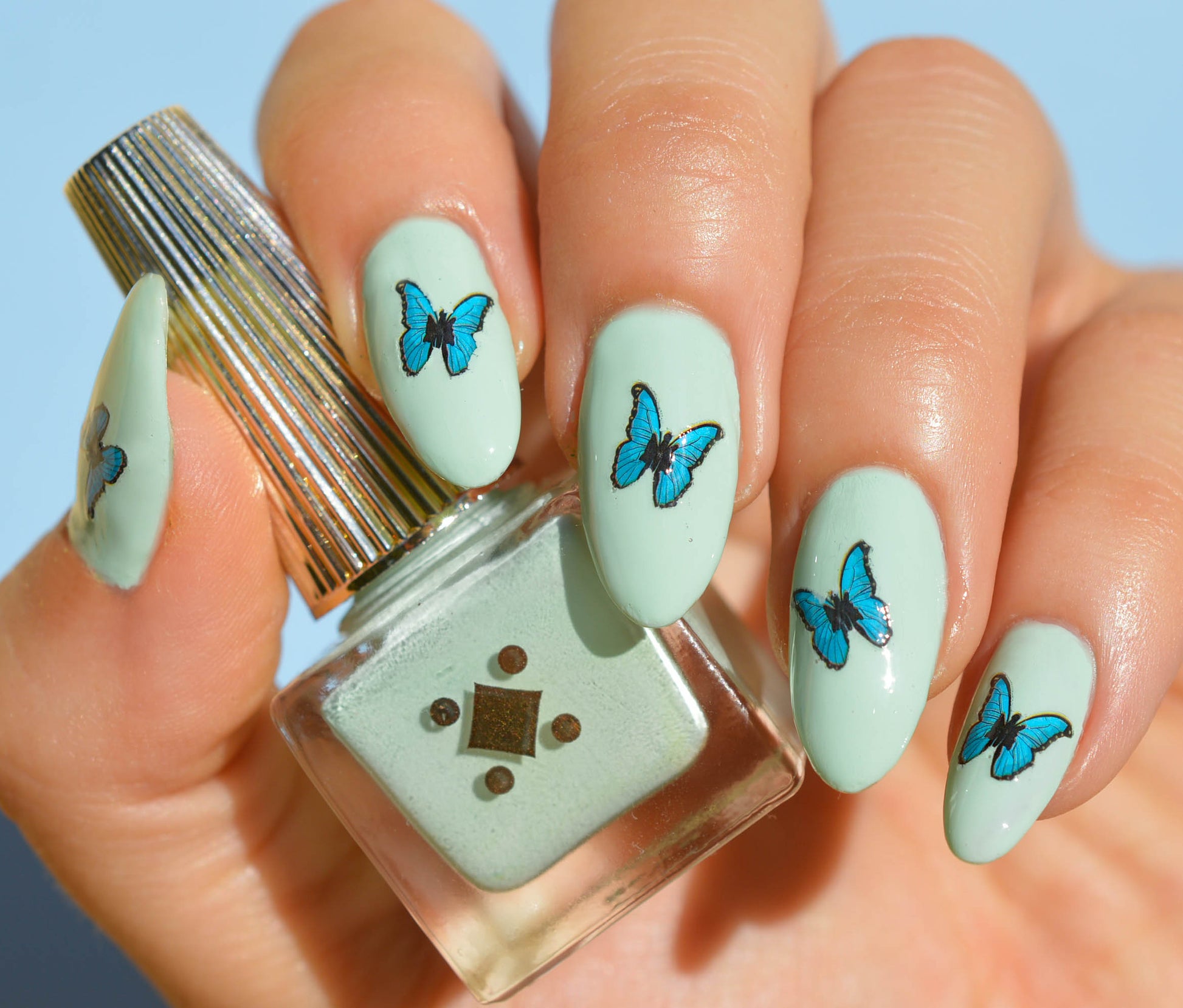 mint nails with blue butterflies